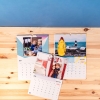Calendarios personalizados con fotos de Fotoprix. Foto comparativa del calendario A4 y del A3 colgados ambos en la pared, apreciando sus tamaños.